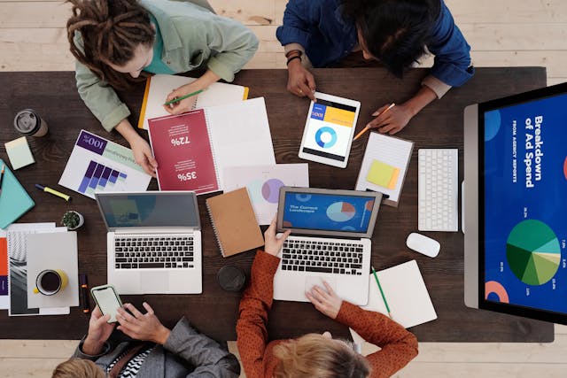 People collaborating at a table in a focused work environment.